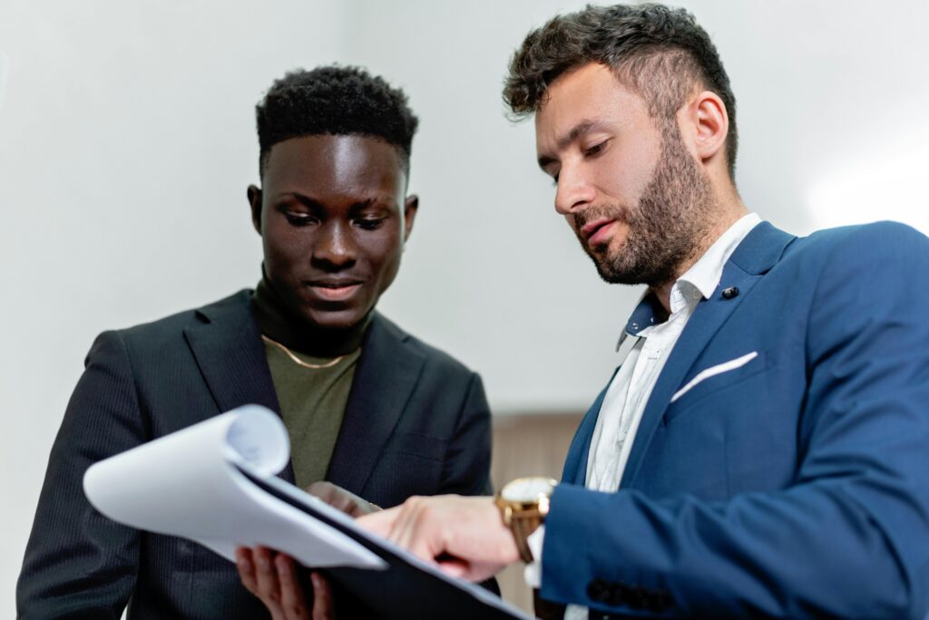 A business development representative speaking with a prospective customer in a professional setting.