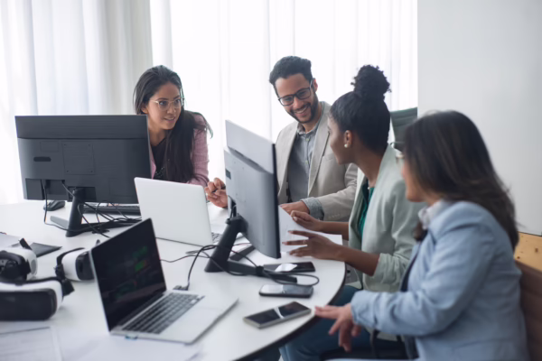 Diverse team collaborating in a modern office environment, demonstrating adaptability and workplace teamwork